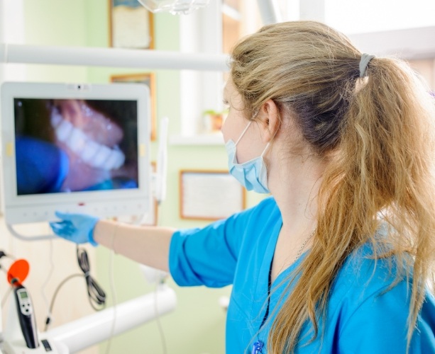 Dentist reviewing photos from intraoral camera