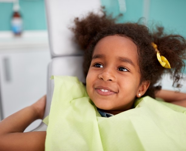 Little girl smiling during dental checkup and teeth cleaning