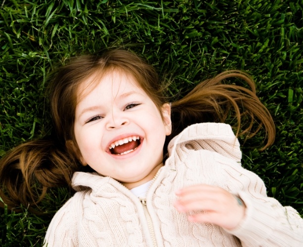 Little girl laughing after dental sealants