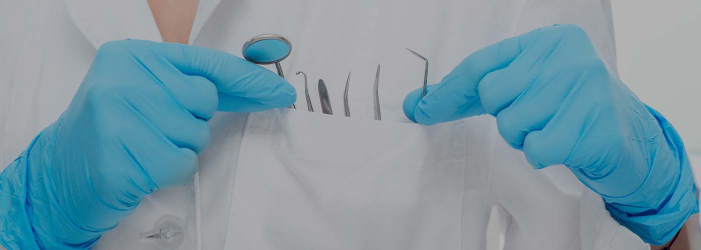 Closeup of dentist with dental tools in lab coat pocket