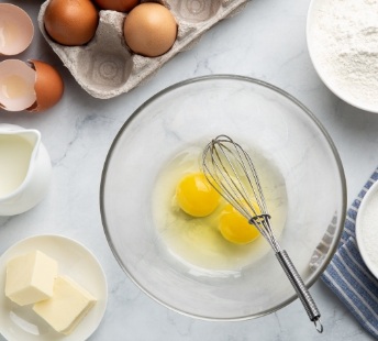 Eggs in bowl with a whisk