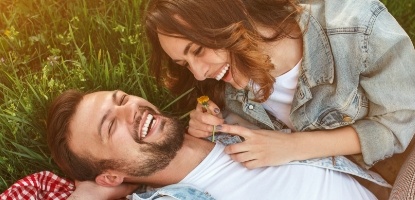 Man and woman laughing together after preventive dentistry visit