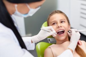 A young girl at her dental appointment.