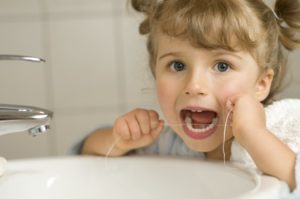 child flossing