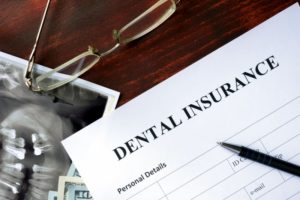 dental insurance form on dark brown wooden table 