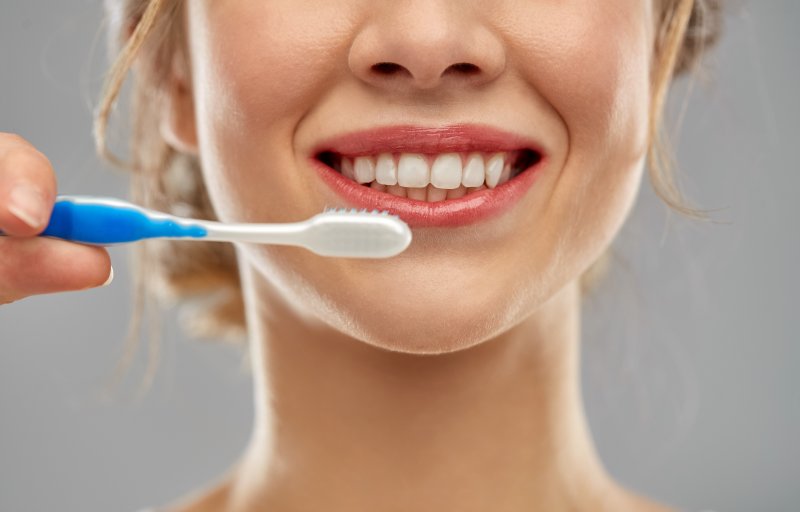 person preparing to brush their teeth for good oral health