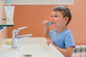 a young child brushing their teeth